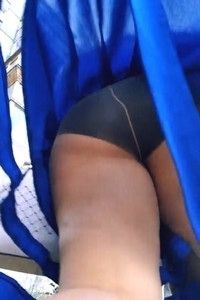 Hot ass under the skirt of a redheaded milf